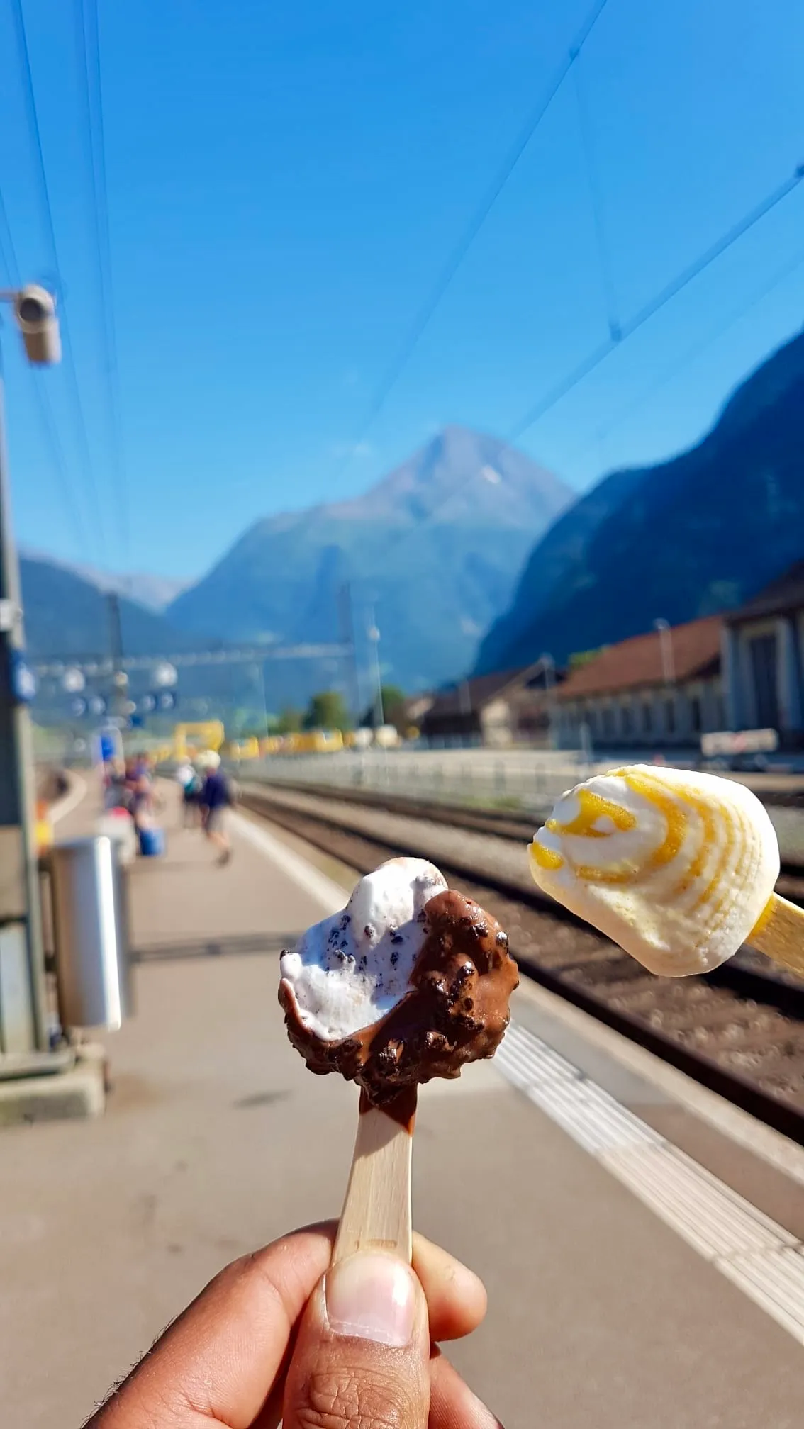 Ice cream at the platform of the train station in Erstfeld with the Bristen rising up the Reuss valley.