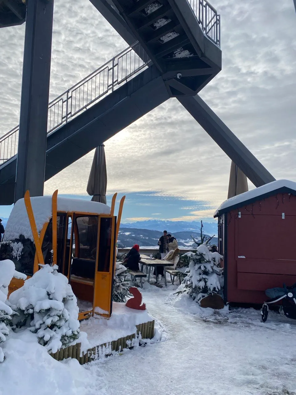 Felsenegg lookout tower with a snowy terrace and mountain hut.