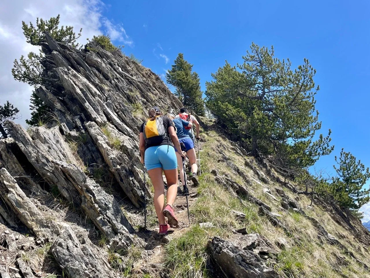 Hikers climbing a rocky ridge.