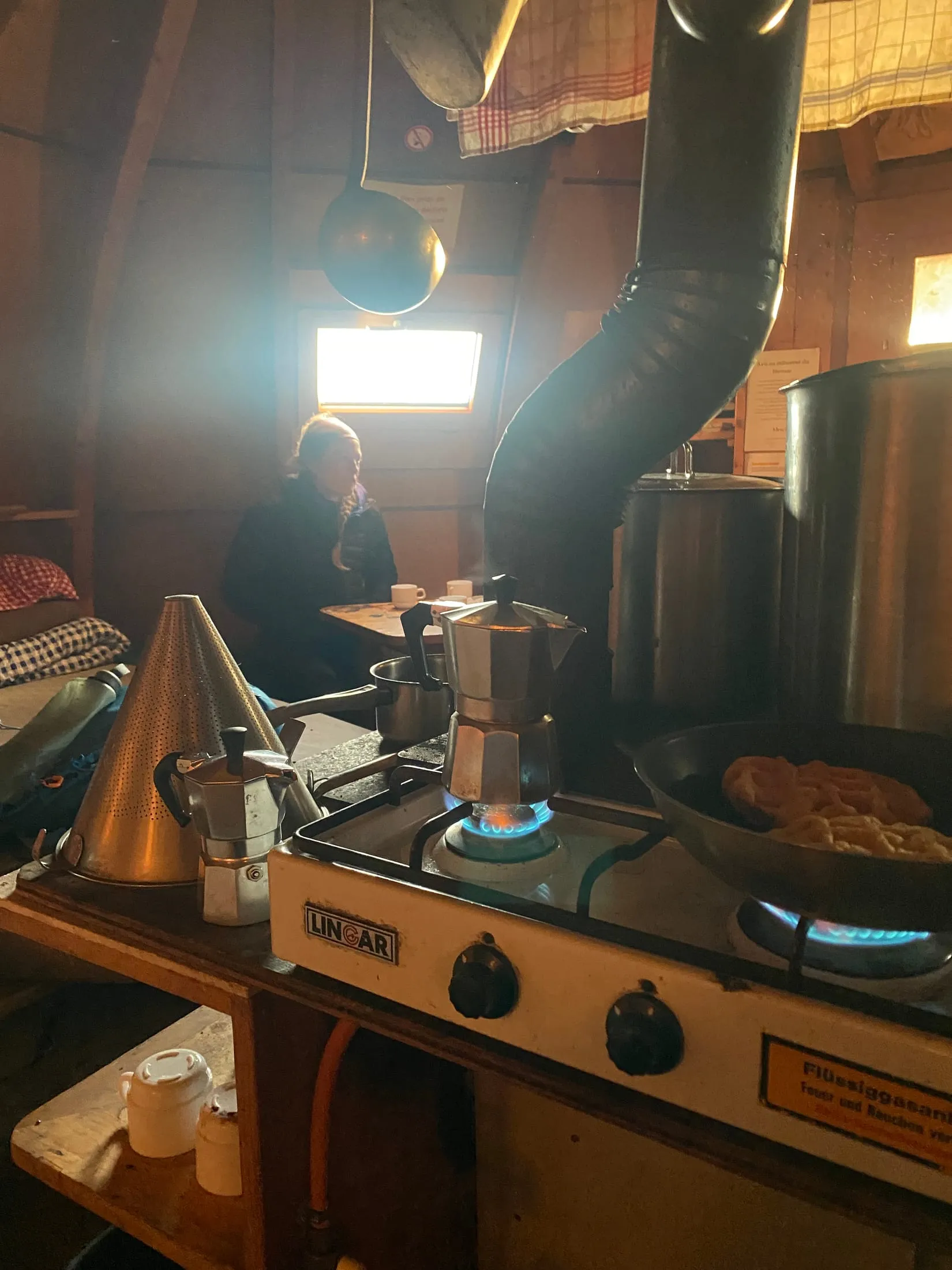 Making coffee on the gas stove in the hut kitchen.