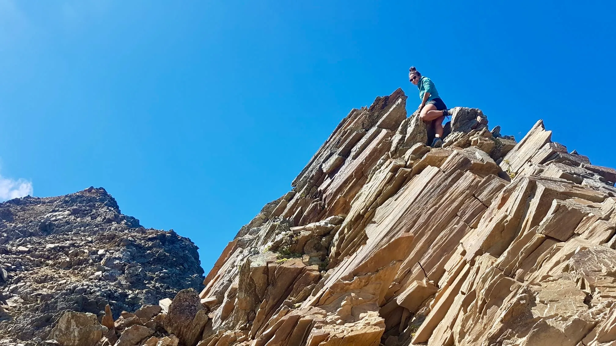 Short scramble on tilted rocky slabs in the pathless summit build-up.