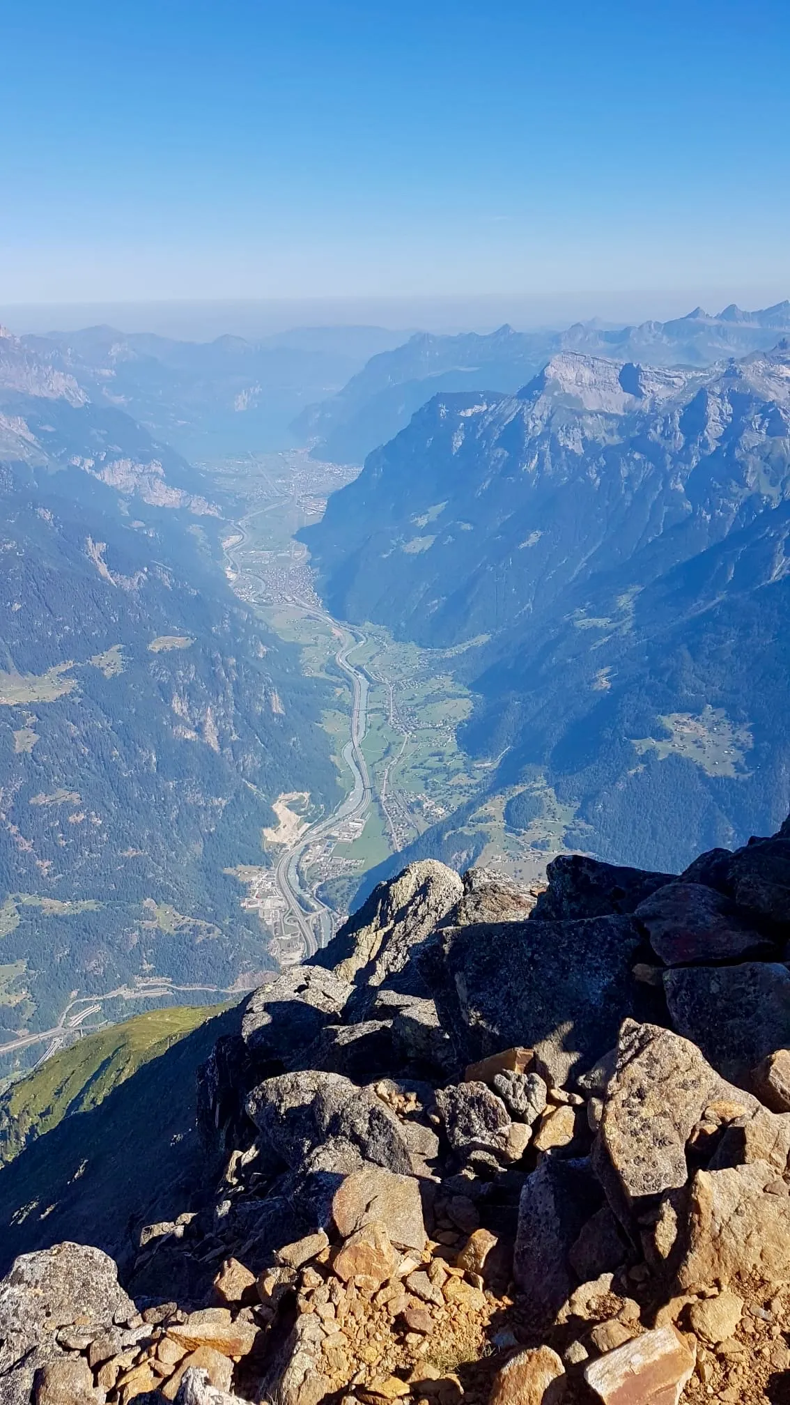 Vertical drop down to the Reuss valley from the rocky summit of the Bristen.