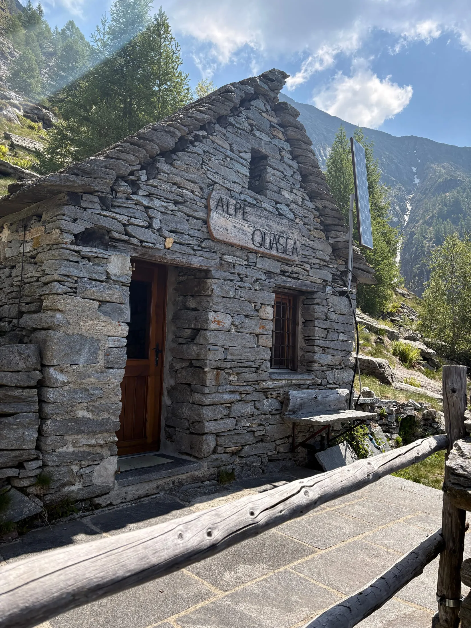 An old Ticino stone hut with "ALPE CUASCA" carved into the lintel above the door.