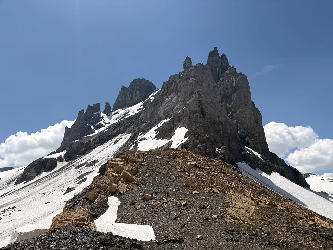The dark, crumbling rock towers of the Gross Spannort seen from the moraine below.