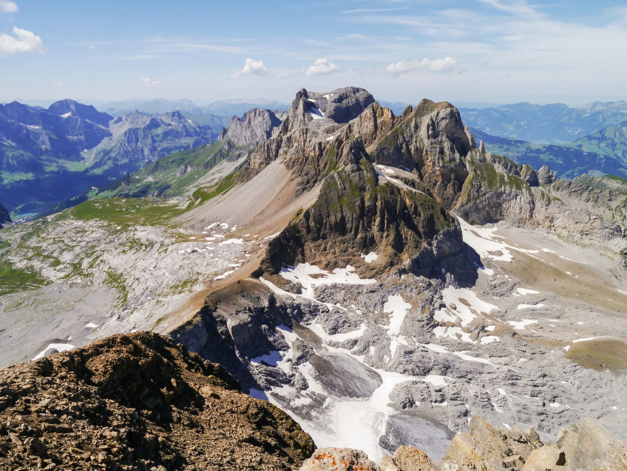 The rocky summit structure of the Engelberger Rotstock in summer, with snow-free peaks and green valleys of the Urner Alps.