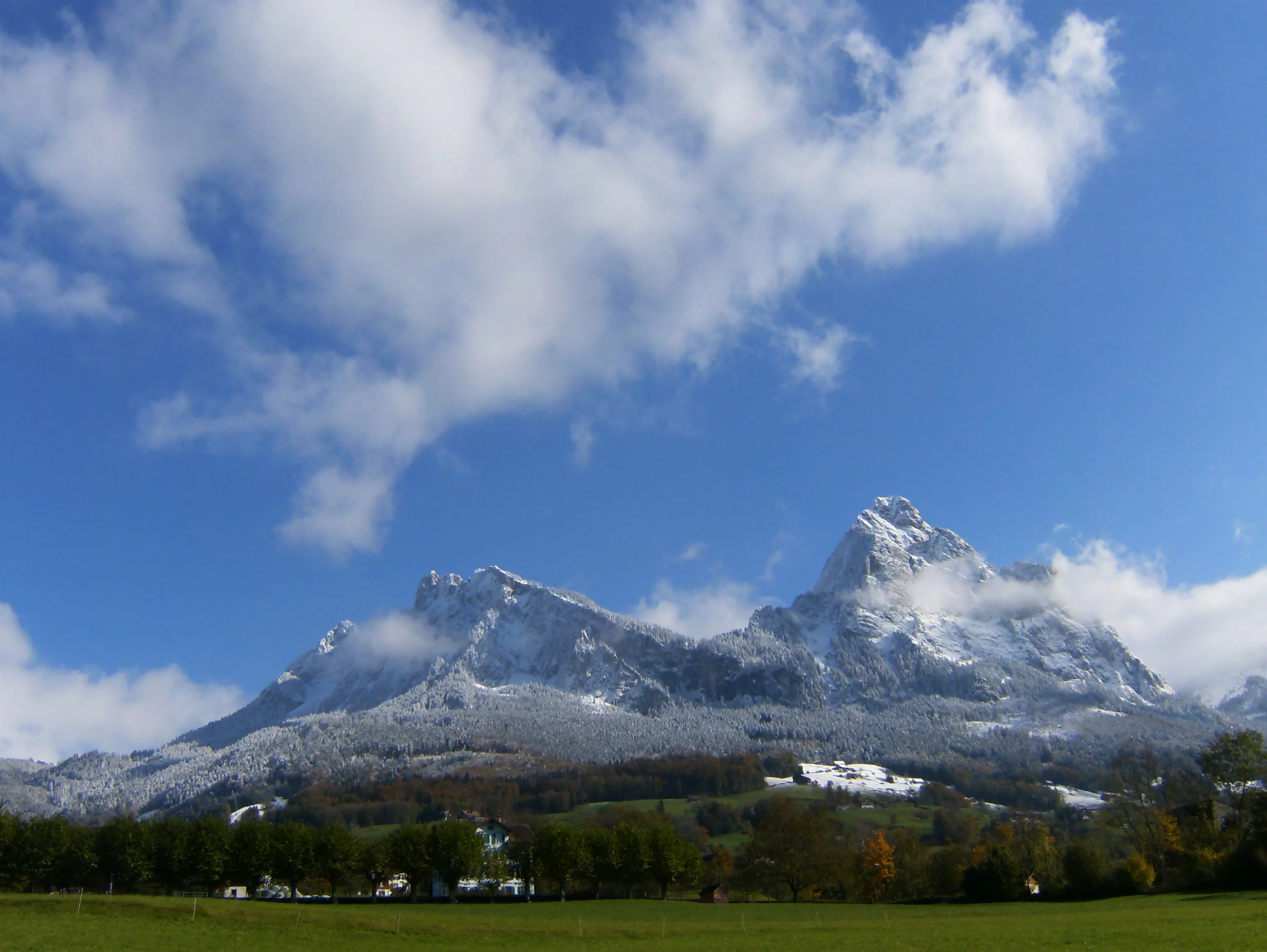 The Grosser Mythen with the Haggenspitz and Kleiner Mythen above the autumn landscape near Schwyz.