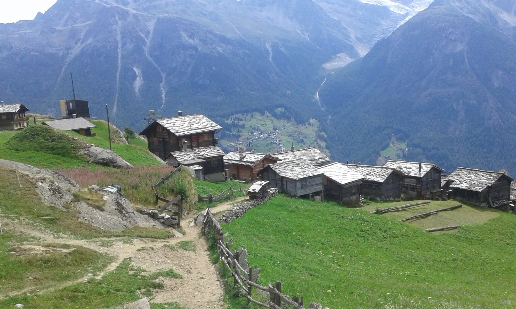 The tiny hamlet of Jungen perched on a grassy shoulder high above the Mattertal.