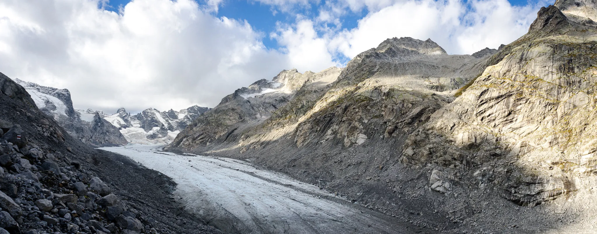 The Forno glacier in the Bregaglia, its ice tongue between rocky flanks, in summer.