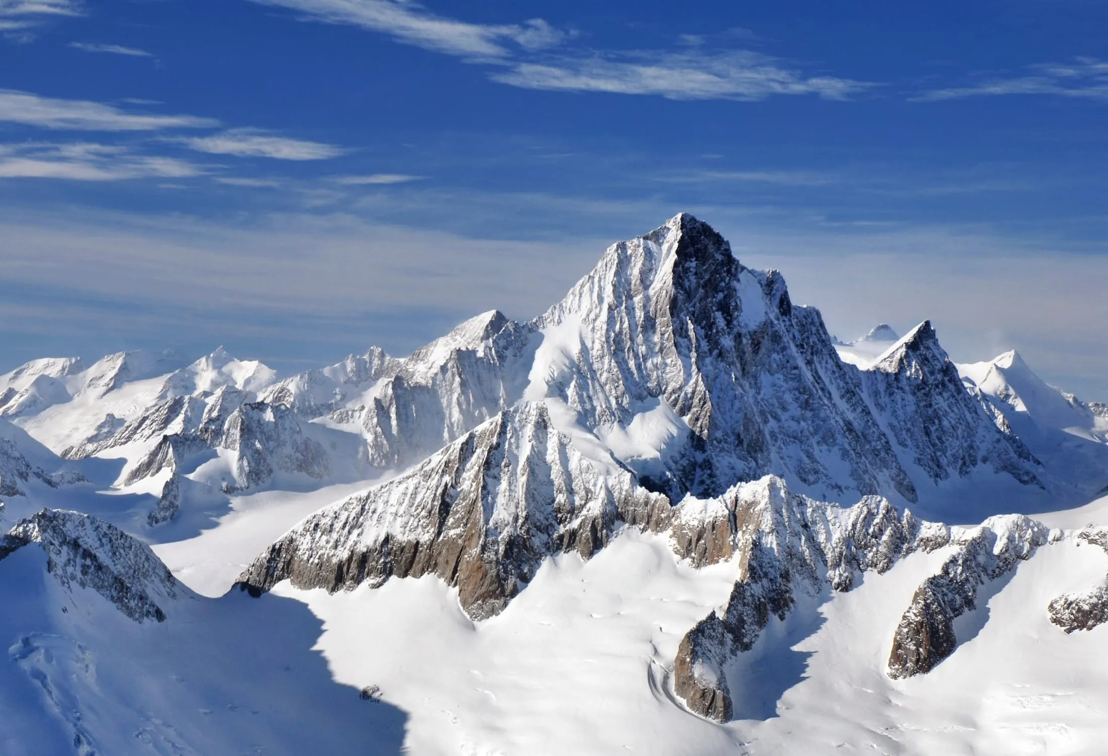 The Finsteraarhorn (4274 m), highest peak of the Bernese Alps, seen from the air above the surrounding snow peaks and glaciers.