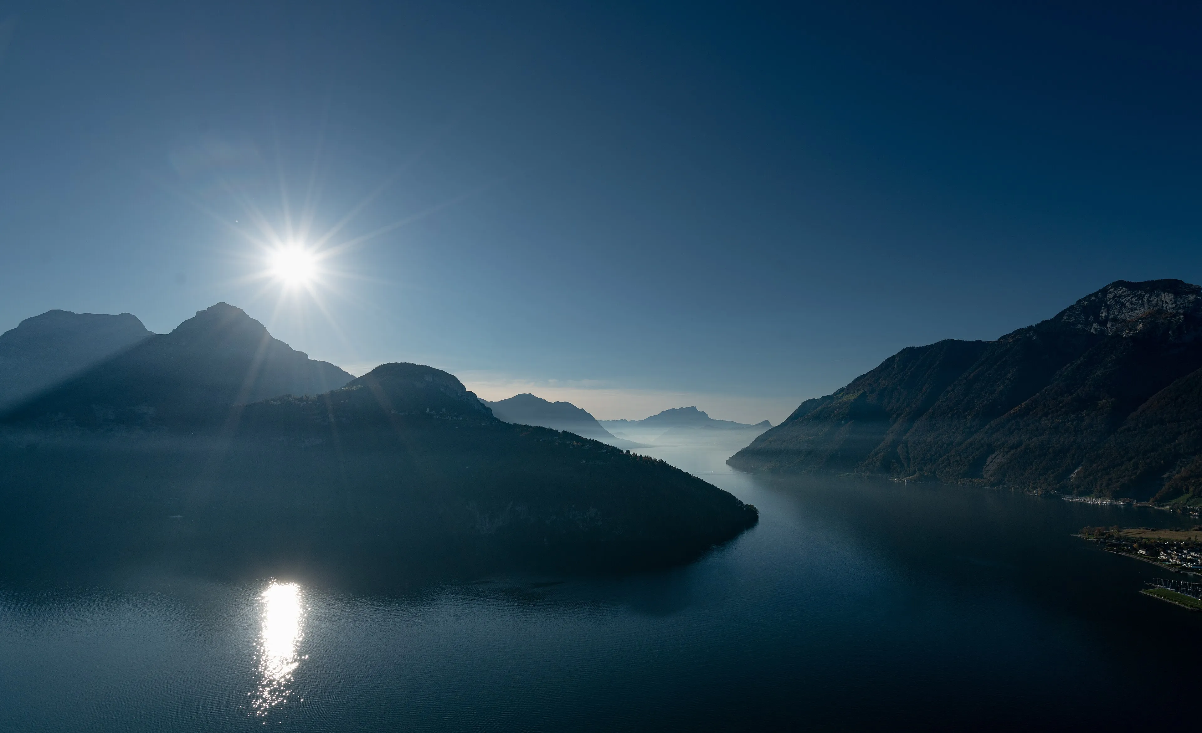 Lake Uri from the Axen in backlight, its still water and the mountains towards Pilatus.