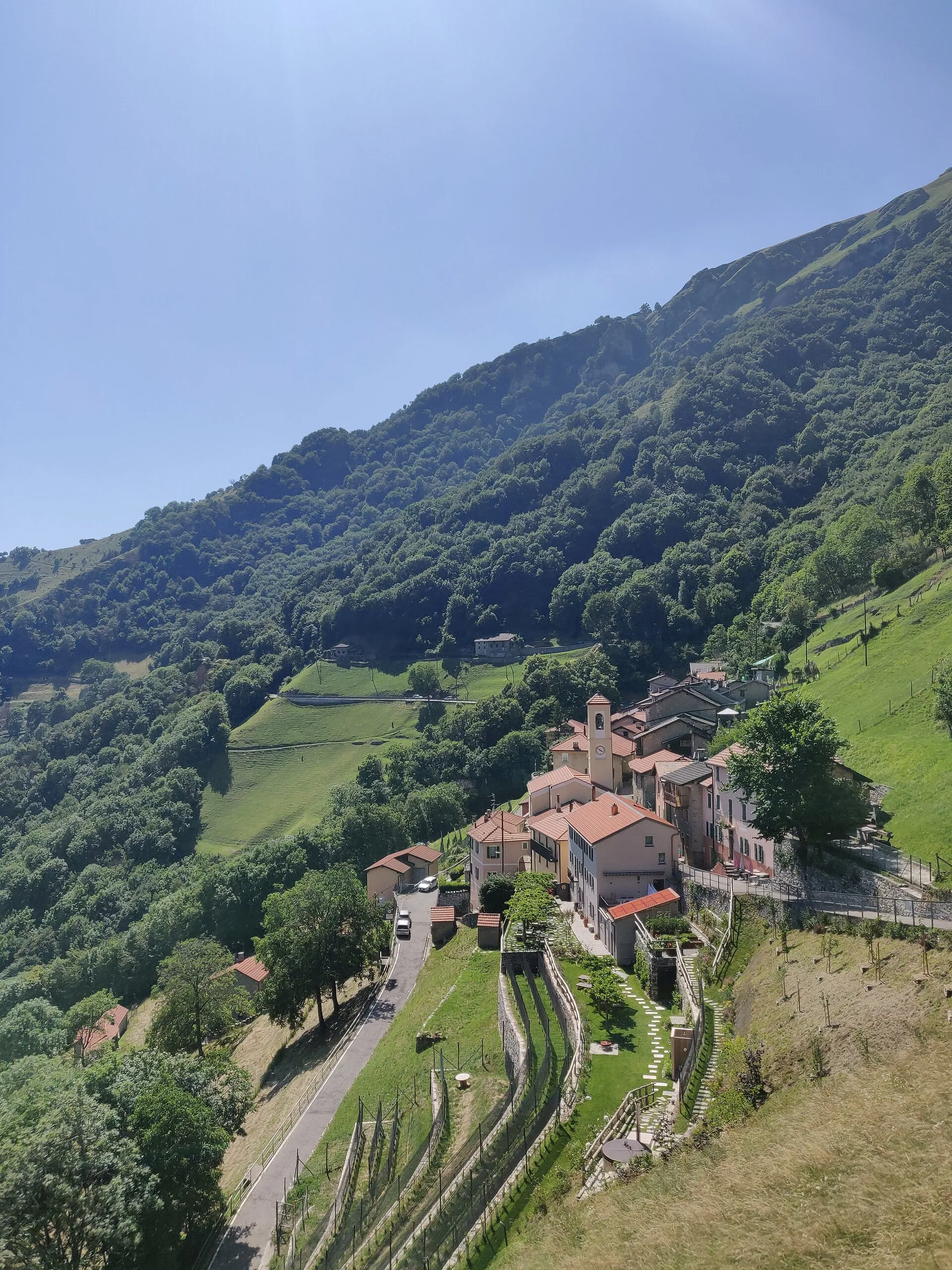 The mountain village of Scudellate clinging to a steep, wooded hillside high above the Muggio valley.