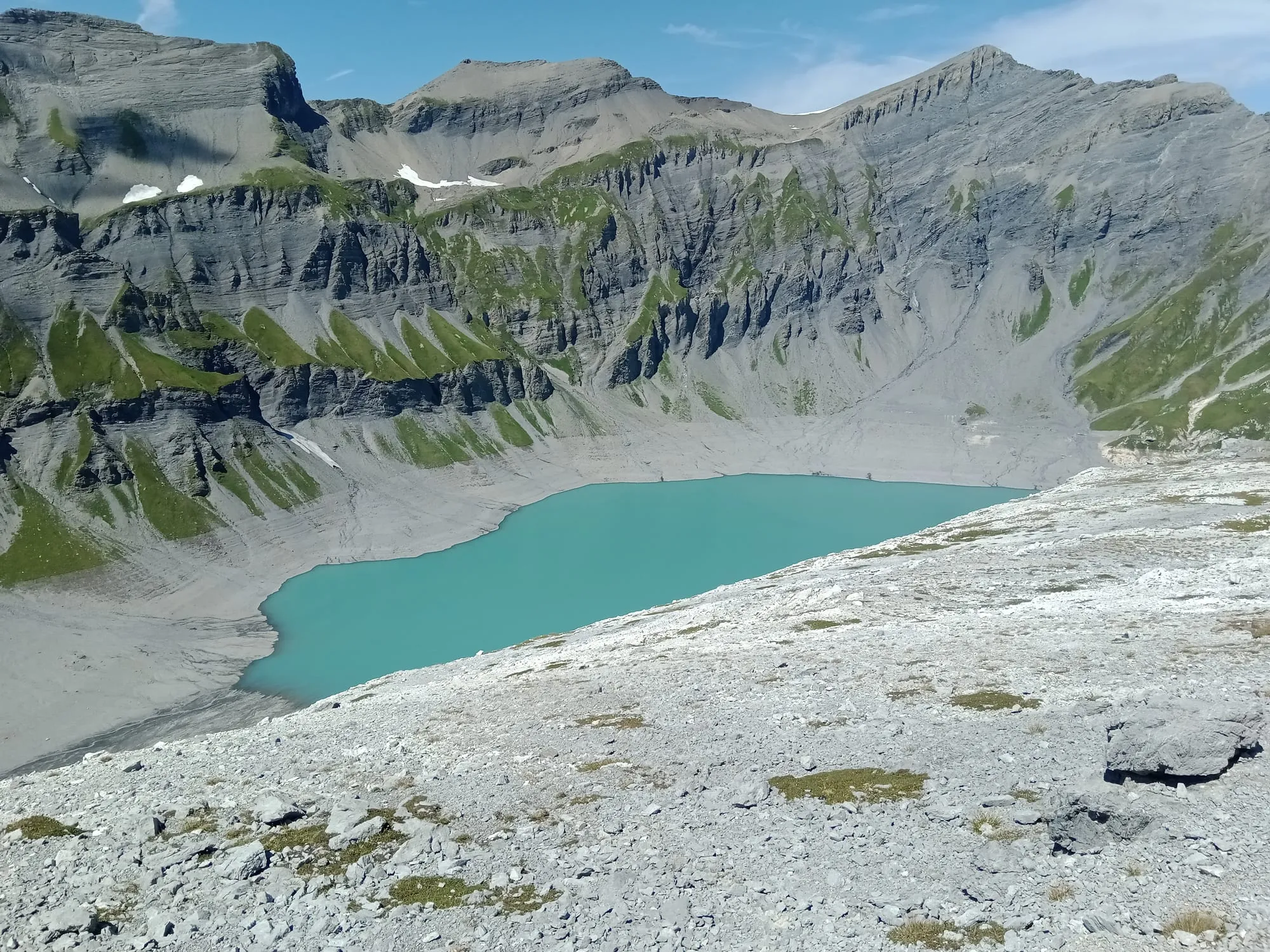 The turquoise Lac du Vieux Emosson reservoir held back by its arch dam high above Finhaut.