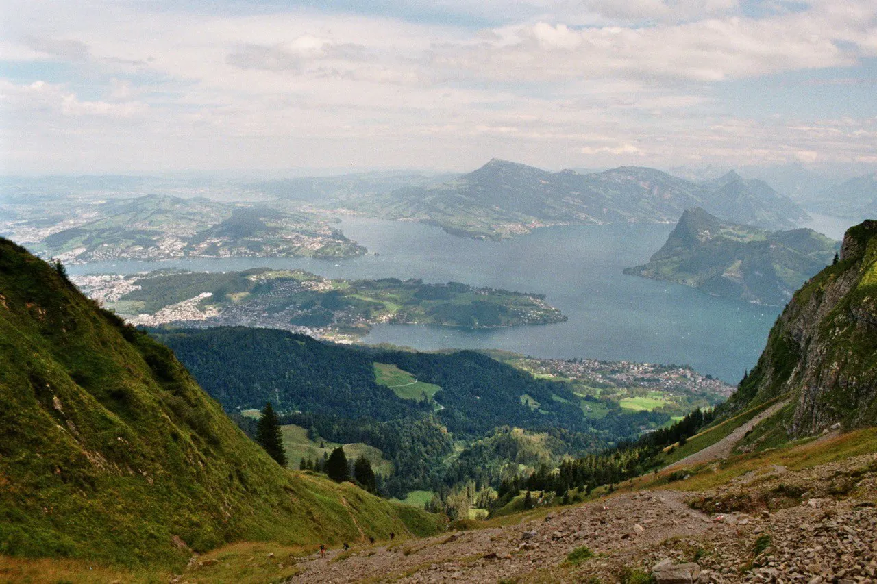 The view down to Lake Lucerne on the descent, the Bürgenstock and Rigi rising across the water above forested slopes and lakeside towns.